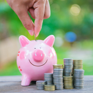 HSA Contributions - Approaching the Tax Deadline (image of a hand putting coins into a piggy bank)